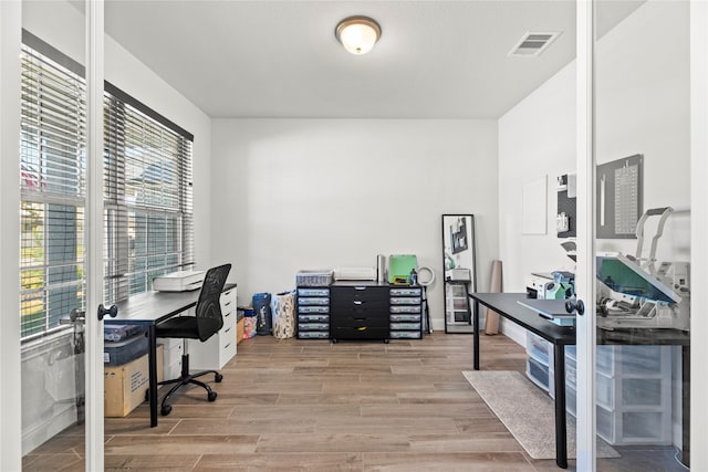 office area with light hardwood / wood-style floors