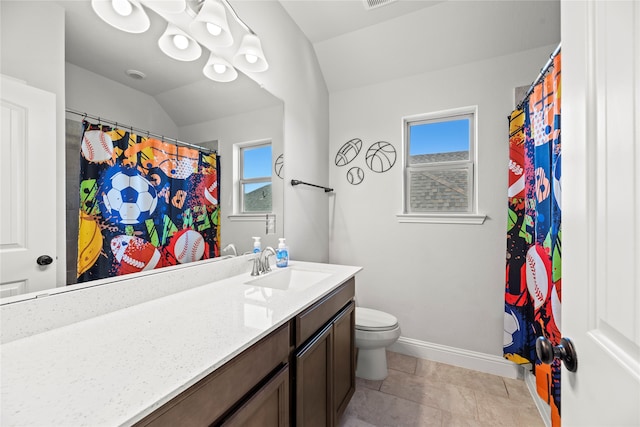 bathroom featuring tile patterned flooring, vanity, vaulted ceiling, and toilet