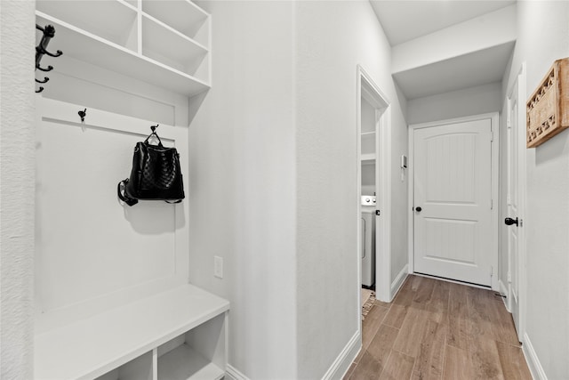 mudroom featuring light wood-type flooring and washer / clothes dryer