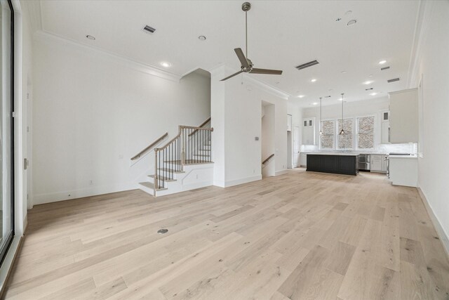7523 Cuadro Ln, Houston, TX 77055 - unfurnished living room with ornamental molding, light wood-style floors, a ceiling fan, stairs, and baseboards
