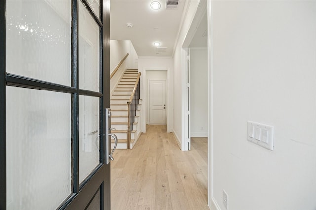7523 Cuadro Ln, Houston, TX 77055 - corridor with light wood-type flooring, stairs, baseboards, and crown molding