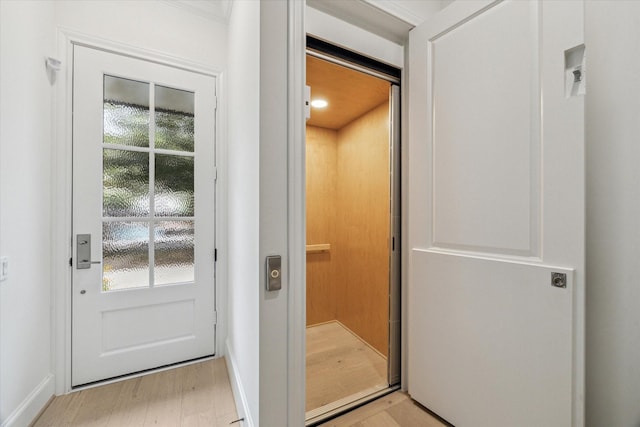 7523 Cuadro Ln, Houston, TX 77055 - doorway featuring healthy amount of natural light, baseboards, elevator, and light wood finished floors
