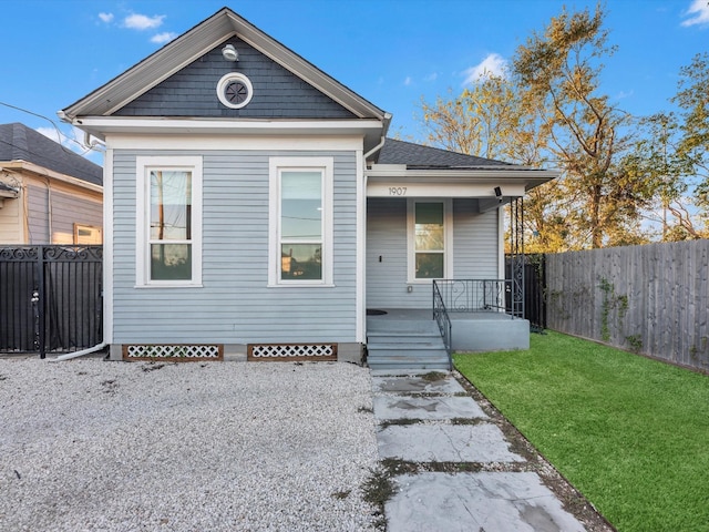 view of front of house with covered porch and a front yard