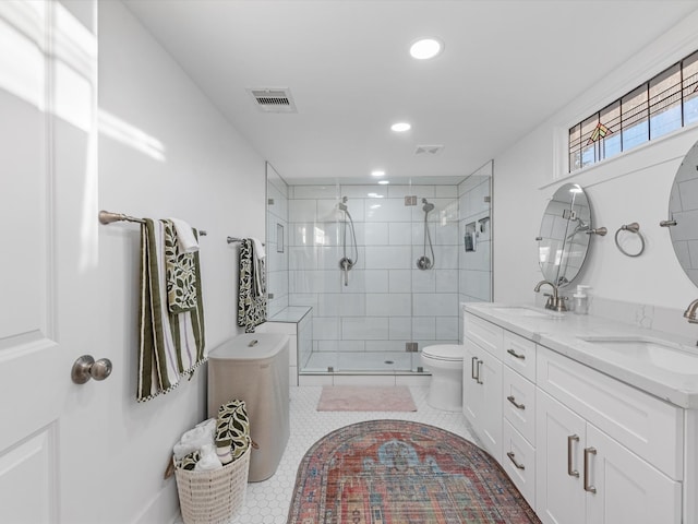 bathroom with tile patterned flooring, vanity, an enclosed shower, and toilet