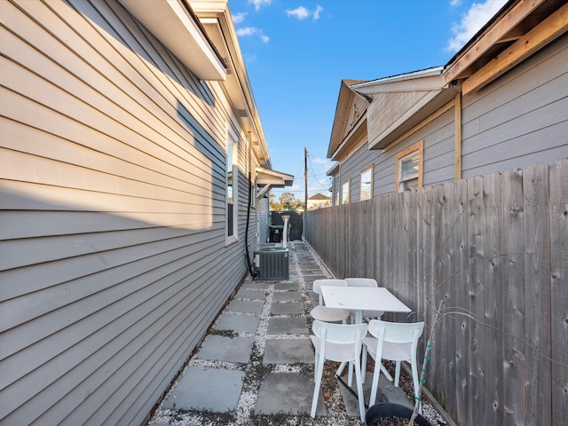 view of home's exterior featuring central air condition unit and a patio