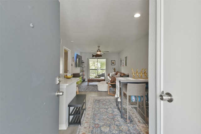 living room featuring ceiling fan and wood-type flooring