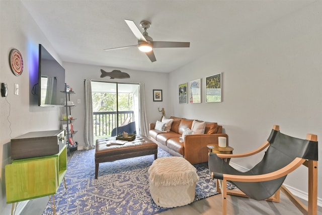 living room with ceiling fan and hardwood / wood-style flooring