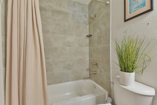 bathroom featuring shower / tub combo with curtain and toilet