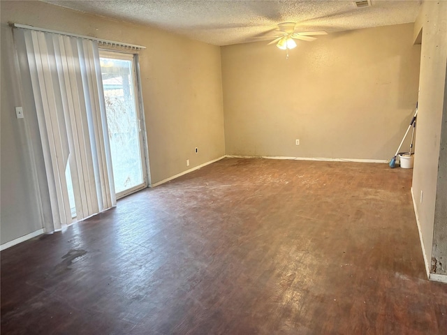 spare room featuring ceiling fan, dark hardwood / wood-style flooring, and a textured ceiling