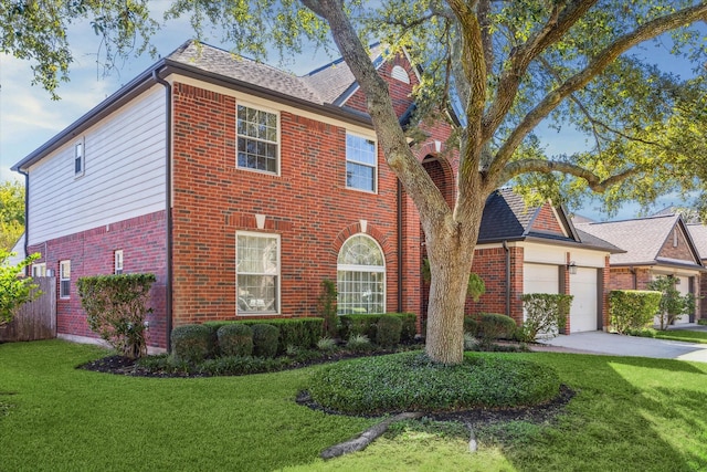 view of front of home with a front yard and a garage