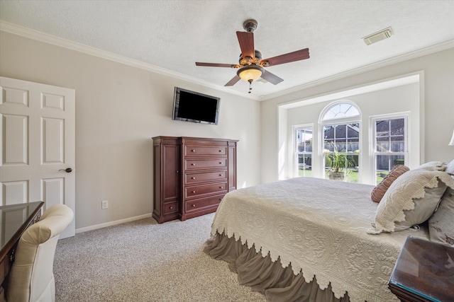 carpeted bedroom with ceiling fan, crown molding, and a textured ceiling