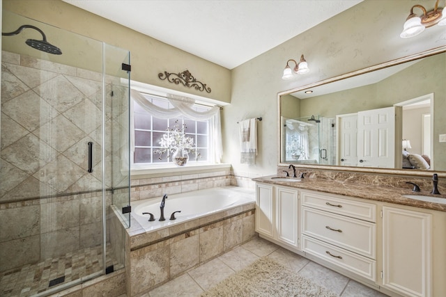 bathroom featuring tile patterned flooring, vanity, and shower with separate bathtub