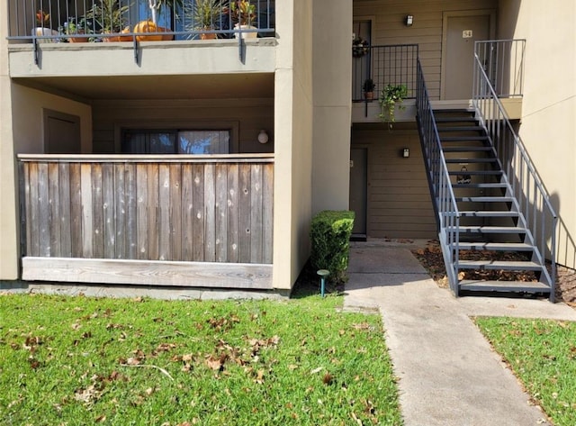 view of exterior entry with a balcony