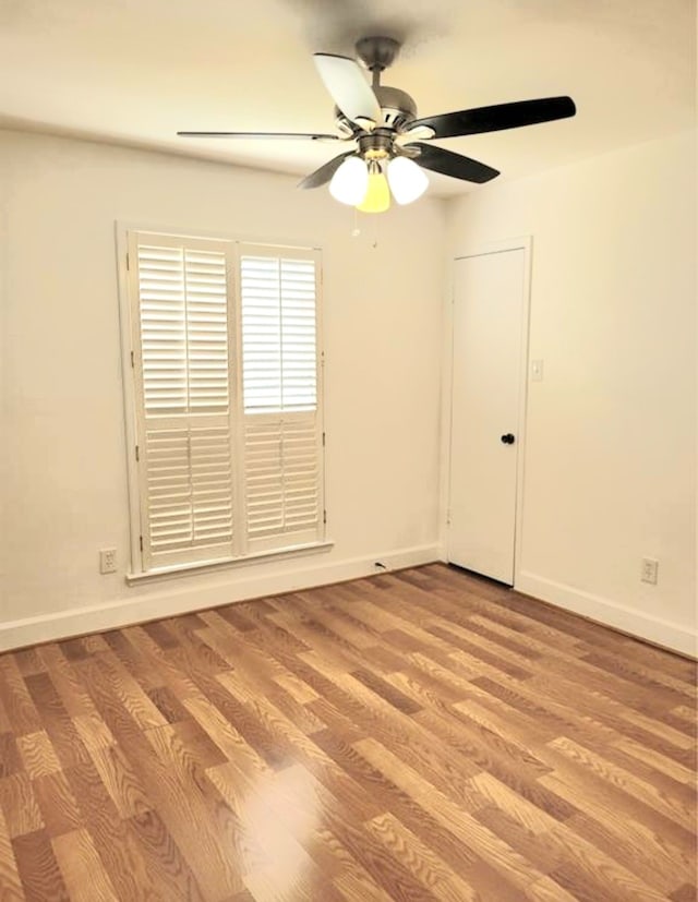 spare room featuring ceiling fan and light wood-type flooring