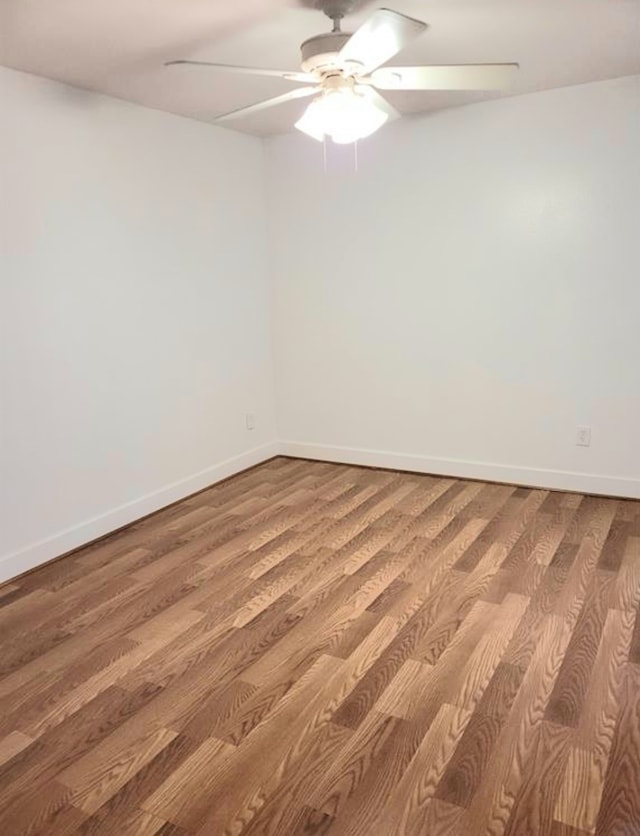 empty room with ceiling fan and wood-type flooring