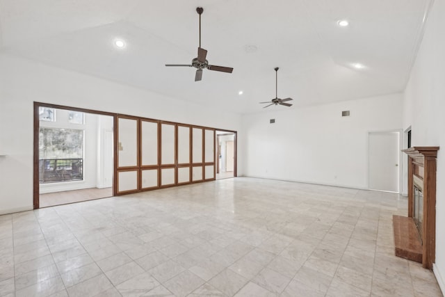 unfurnished living room featuring ceiling fan and high vaulted ceiling