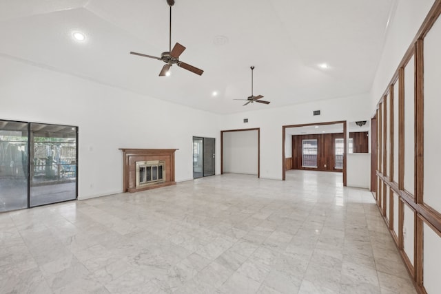 unfurnished living room featuring ceiling fan and high vaulted ceiling