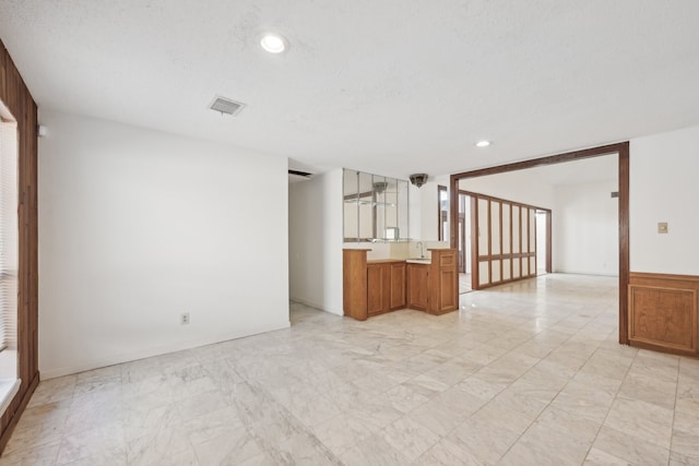 empty room with a textured ceiling and sink