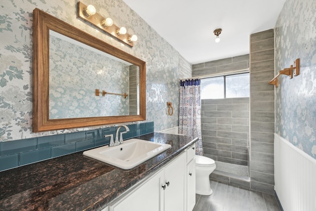 bathroom featuring hardwood / wood-style floors, vanity, toilet, and curtained shower