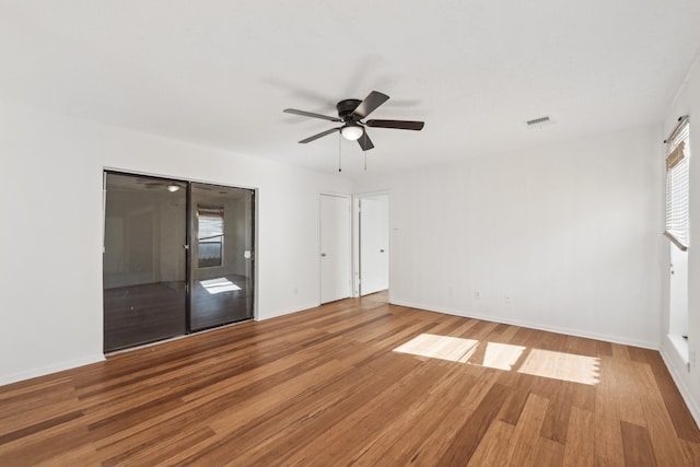 unfurnished bedroom with ceiling fan and hardwood / wood-style floors