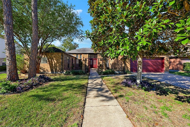 view of front of property featuring a garage and a front lawn