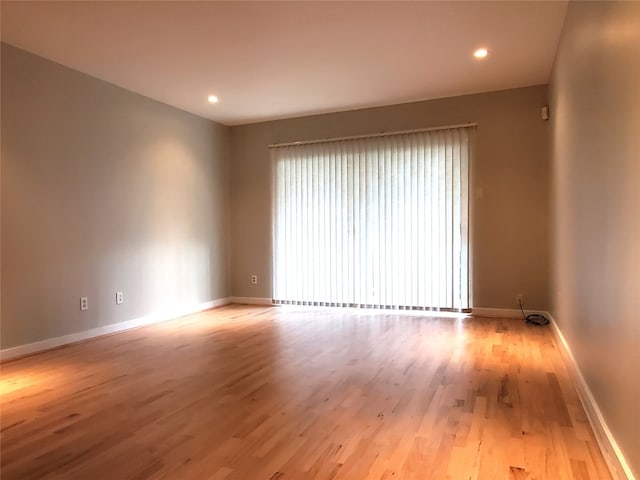 unfurnished room with light hardwood / wood-style floors