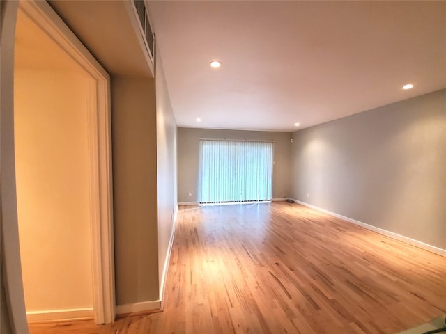 unfurnished room with light wood-type flooring