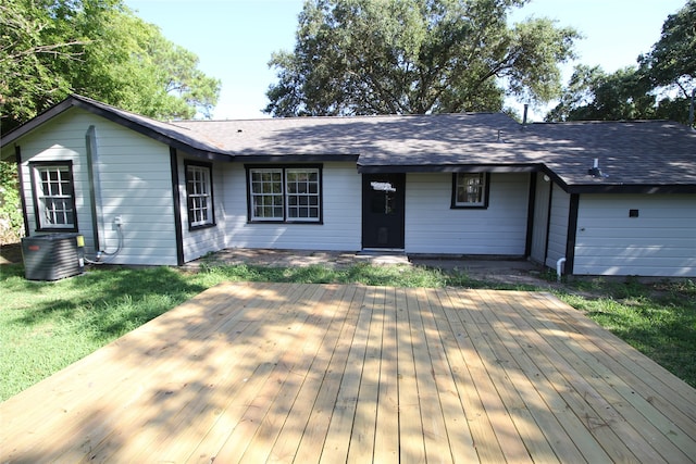 rear view of property with a yard, central AC, and a deck