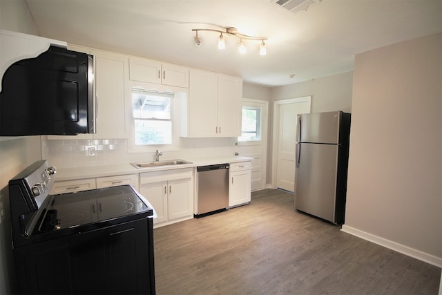 kitchen with sink, white cabinets, a healthy amount of sunlight, and appliances with stainless steel finishes