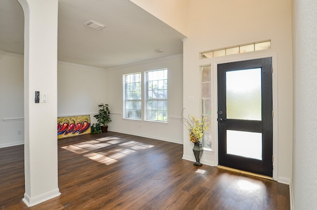 entrance foyer featuring crown molding and dark hardwood / wood-style flooring