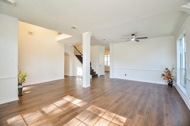 unfurnished living room featuring ceiling fan, ornamental molding, and dark hardwood / wood-style floors