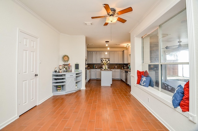 interior space featuring crown molding, light wood-type flooring, and ceiling fan