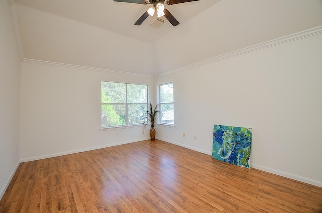 spare room featuring light hardwood / wood-style flooring, ceiling fan, and vaulted ceiling