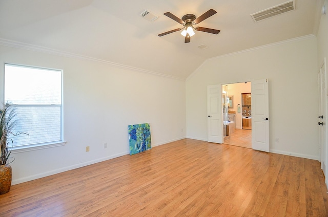 unfurnished room featuring lofted ceiling, ornamental molding, light hardwood / wood-style floors, and ceiling fan