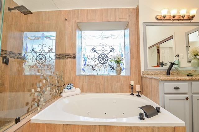 bathroom featuring shower with separate bathtub and vanity