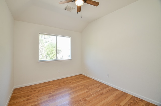 unfurnished room with ceiling fan, lofted ceiling, and light wood-type flooring