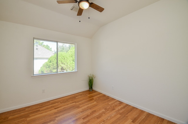 empty room with vaulted ceiling, ceiling fan, and light hardwood / wood-style floors