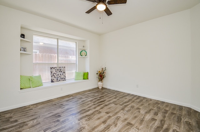 spare room with wood-type flooring and ceiling fan