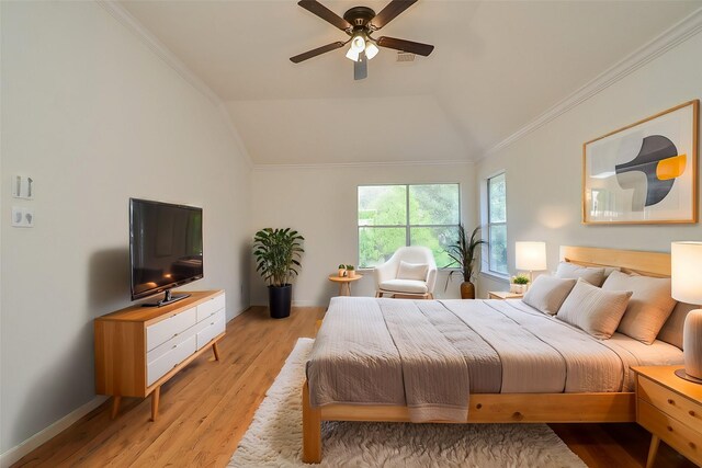 bedroom featuring light hardwood / wood-style flooring, crown molding, vaulted ceiling, and ceiling fan