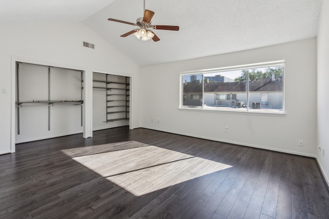 unfurnished bedroom with ceiling fan, dark hardwood / wood-style floors, a textured ceiling, and high vaulted ceiling