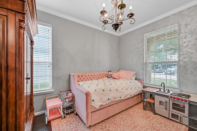 bedroom featuring a chandelier, light hardwood / wood-style flooring, and crown molding