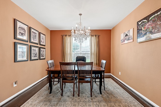 dining area featuring hardwood / wood-style floors and a chandelier