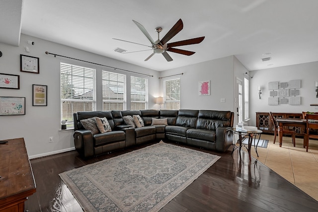 living room featuring dark hardwood / wood-style floors and ceiling fan