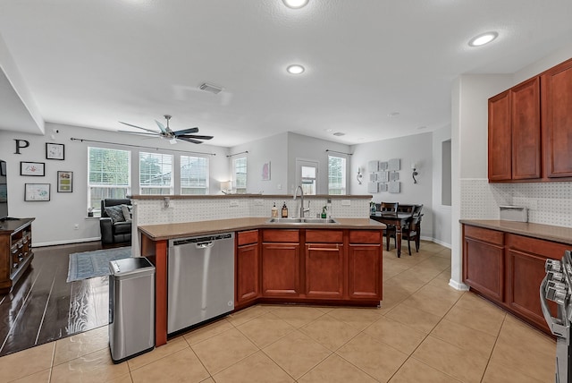 kitchen featuring a wealth of natural light, sink, ceiling fan, and stainless steel appliances