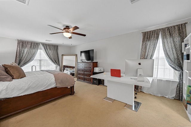 bedroom with ceiling fan and light colored carpet