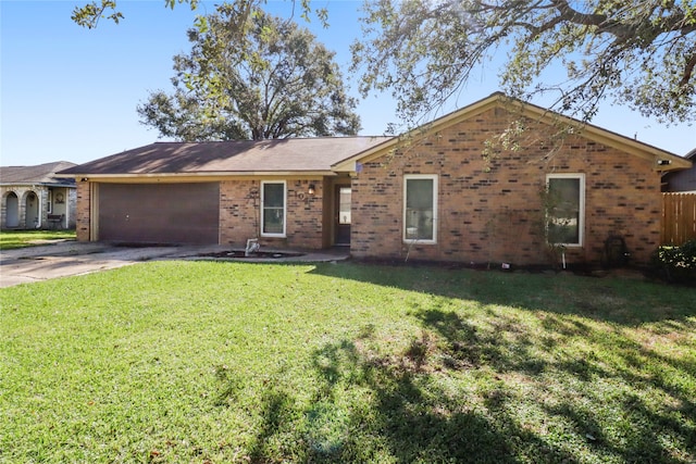 ranch-style home featuring a garage and a front lawn