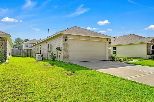 exterior space featuring central air condition unit, a lawn, and a garage