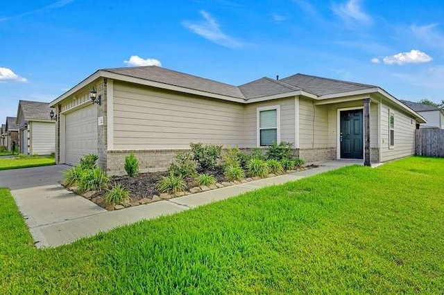 view of front of home with a front yard and a garage