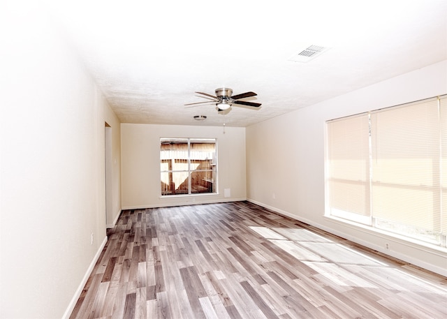 spare room featuring light hardwood / wood-style floors and ceiling fan