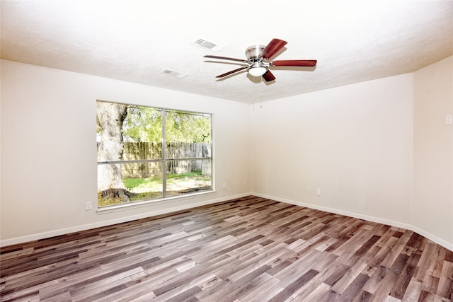 spare room with ceiling fan, light hardwood / wood-style flooring, and a textured ceiling